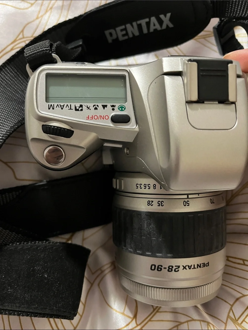 Pentax Silver and Black DSLR with 28-90mm Zoom Lens and Branded Strap